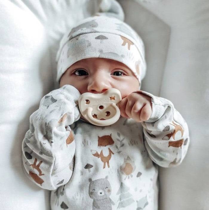Hevea orthodontic pacifier made of natural rubber for babies 0-3 months in baby blue and milky white.
