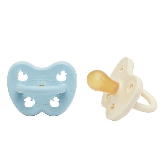 Hevea round natural rubber pacifiers for 0-3 months, pack of two in baby blue and milky white.