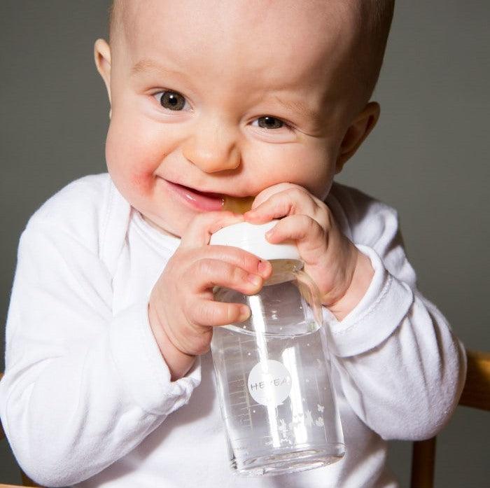 Baby using Hevea natural rubber bottle nipple.
