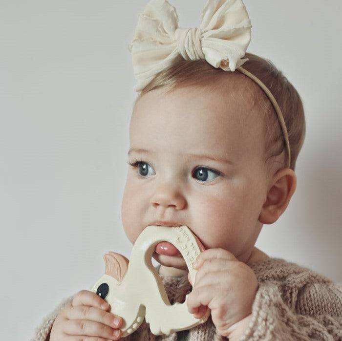 Baby using Hevea Bumibebe teether made of natural rubber.