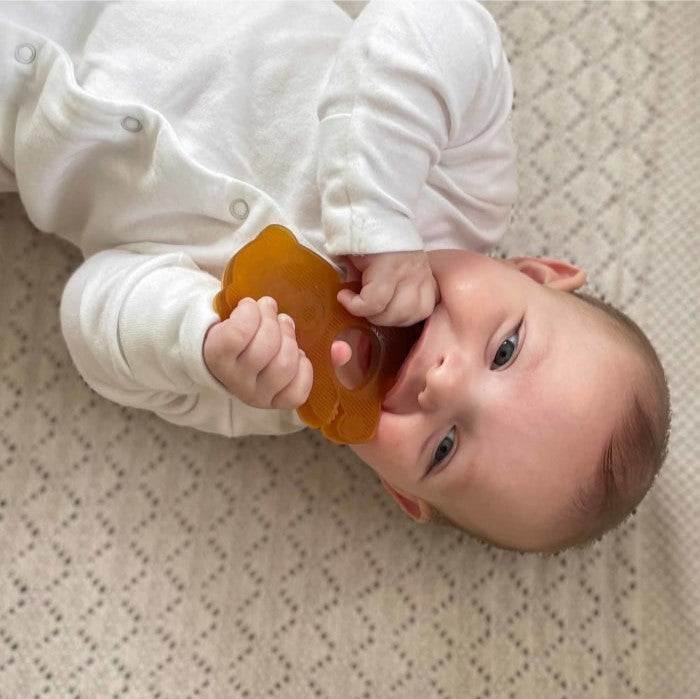 Baby using Hevea Bumibebe teething toy made from natural rubber.